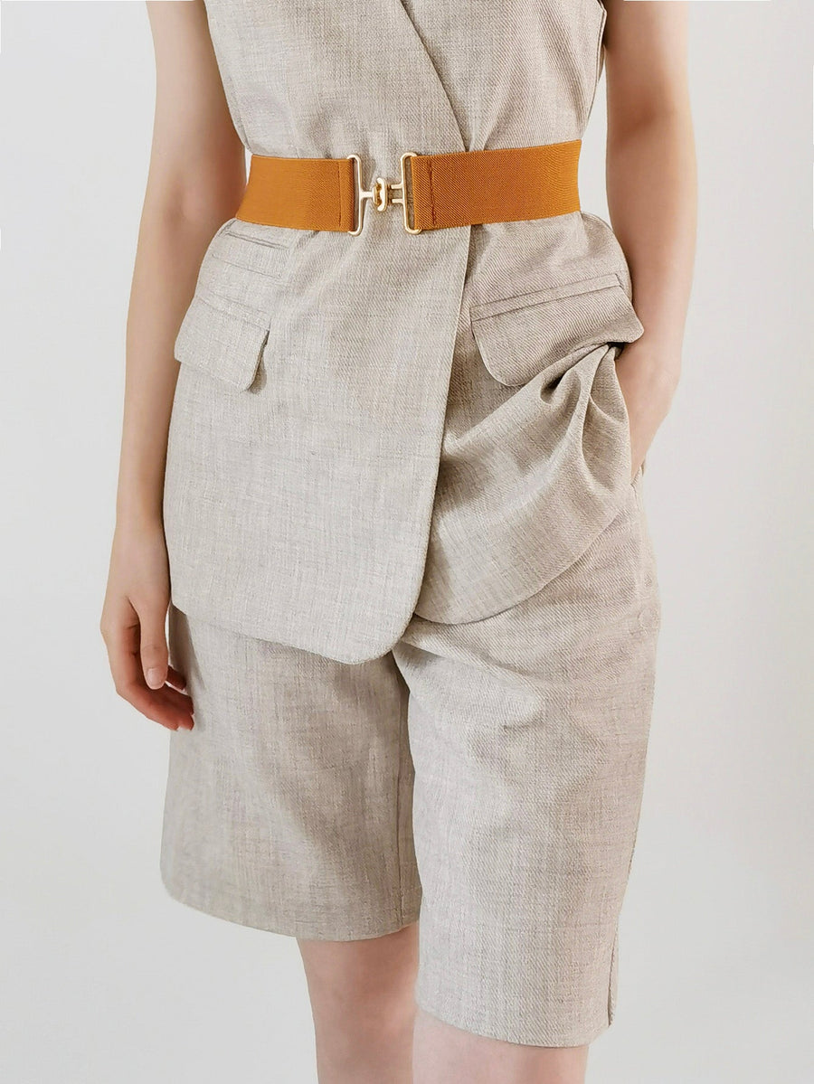 Caramel elastic belt with gold buckle detail cinching a linen blend outfit