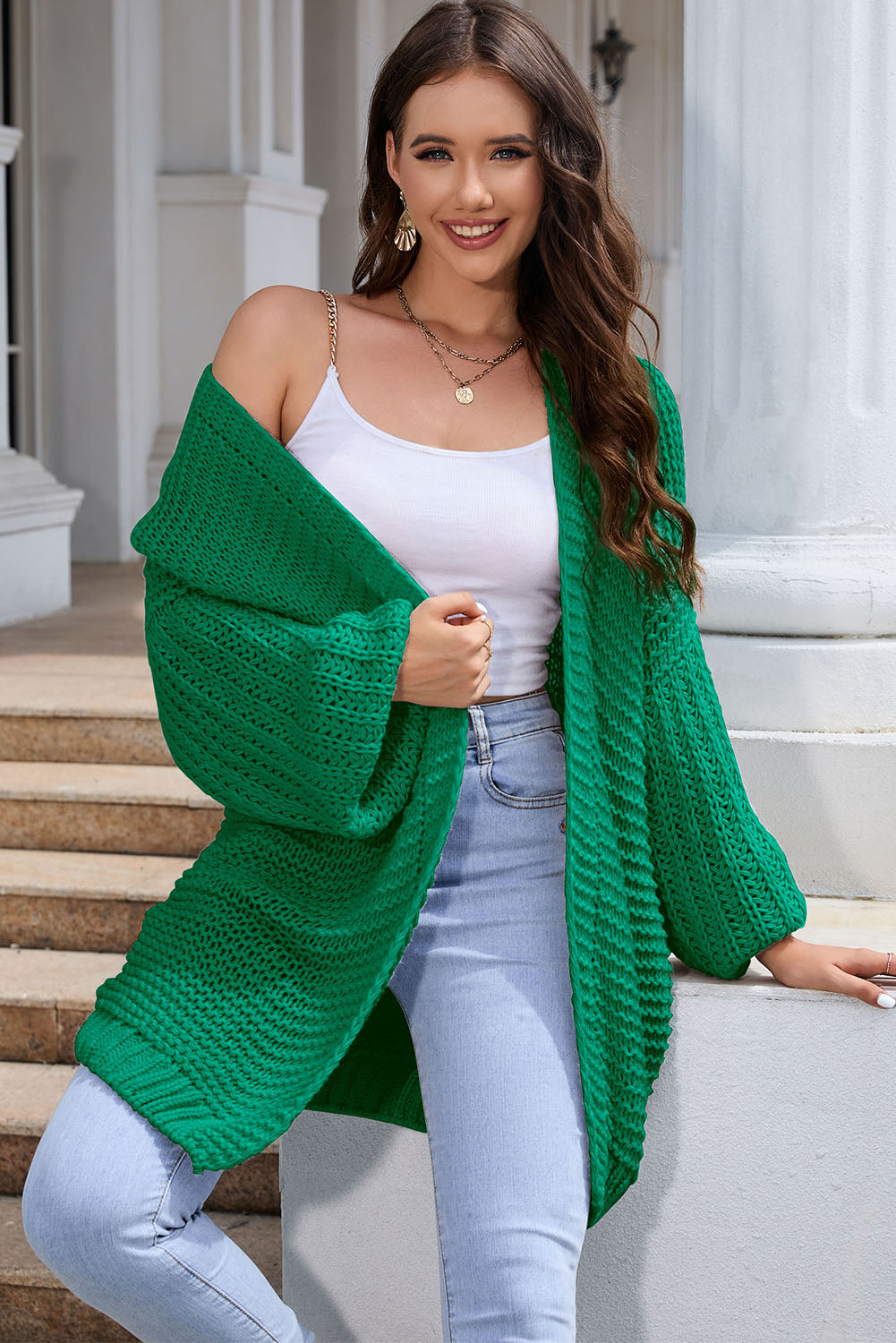 Mid green textured knit cocoon cardigan with balloon sleeves and open front.