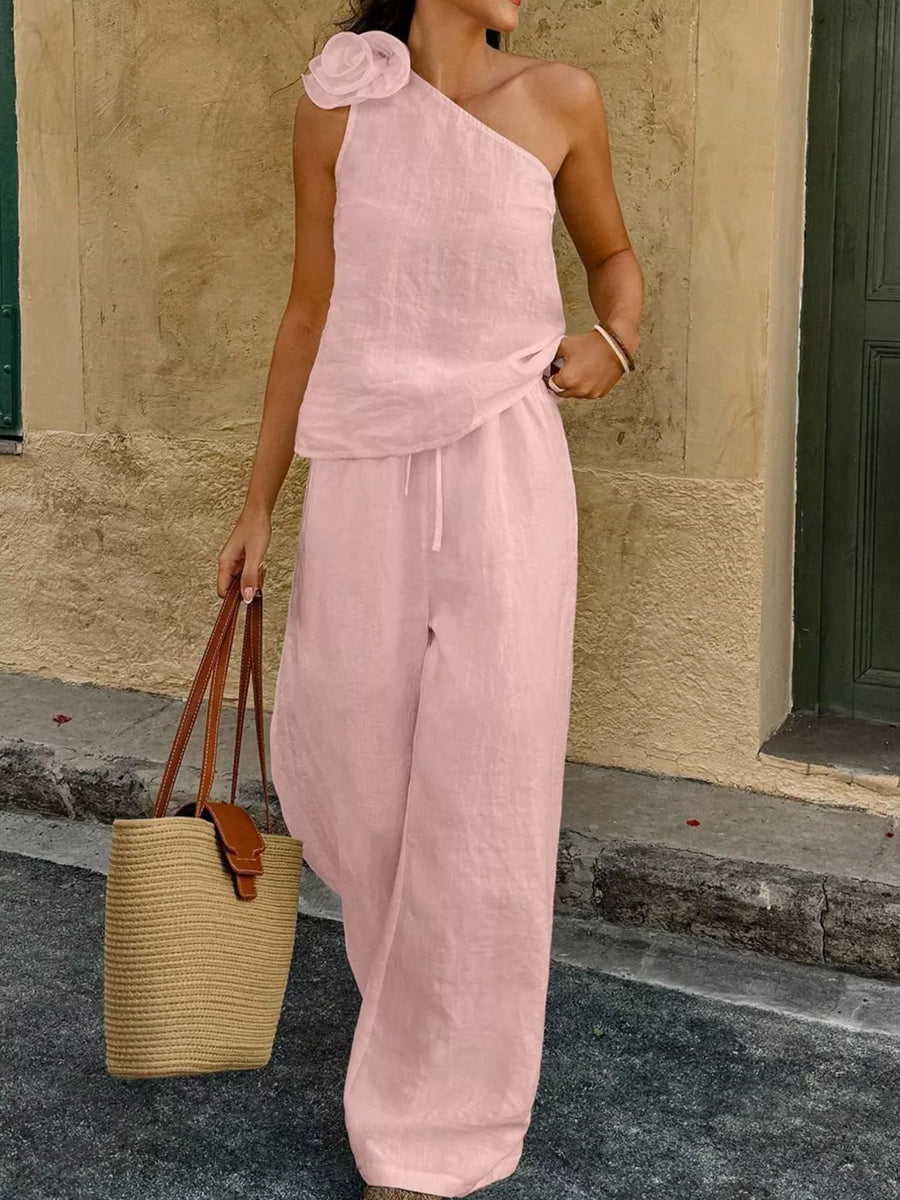 Pink floral embellished one-shoulder top and wide-leg pants set with drawstring waist.