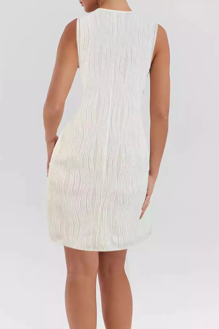 White textured mini dress with V-neck and ring straps, cotton blend, asymmetrical hem.