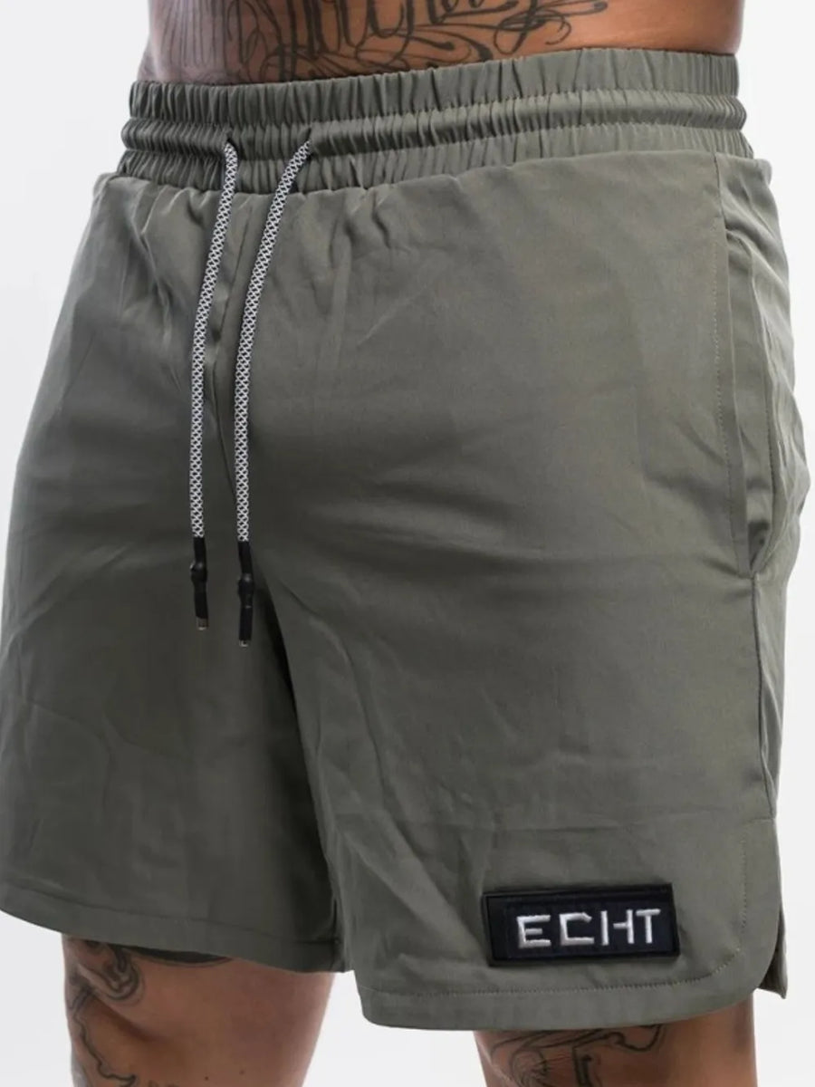 Army green performance drawstring shorts with logo patch and pockets.