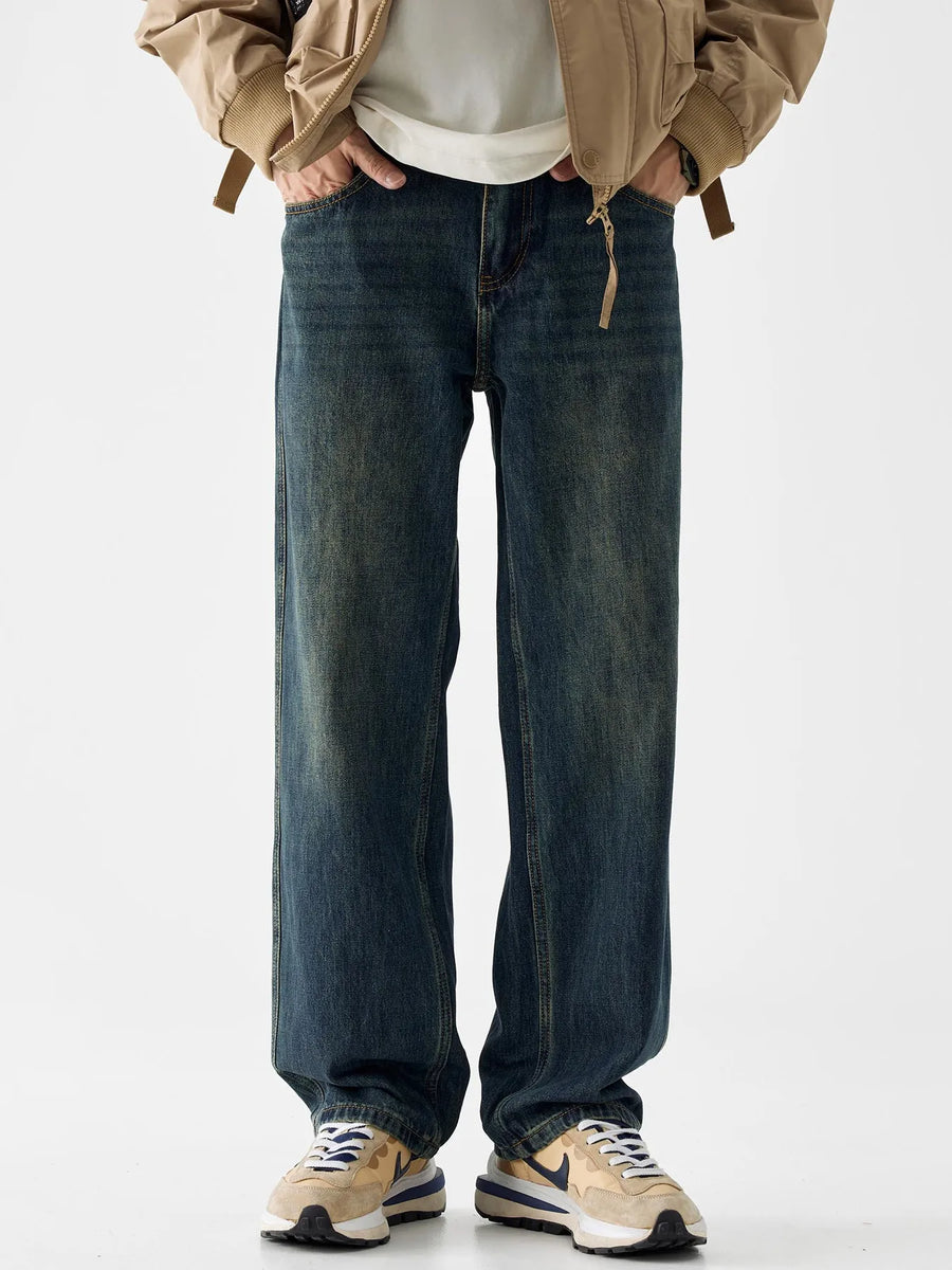 Loose fit blue cotton denim jeans with vintage wash and distressed details.