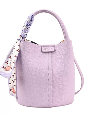 Chic purple bucket crossbody bag with decorative scarf on handle.