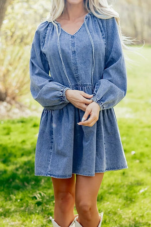 mini dress in medium wash denim blue featuring tied and loose fit