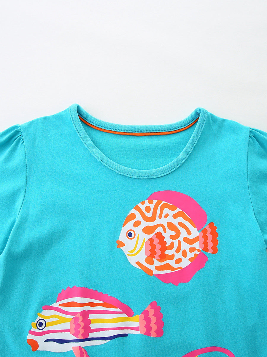Turquoise cotton t-shirt with playful fish print and puff sleeves.