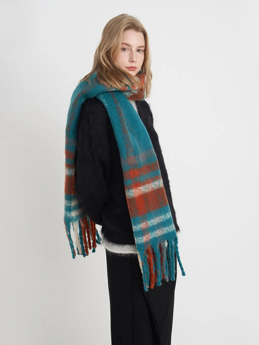 Textured plaid fringe wrap scarf in blue/orange/white plaid with fringed ends.