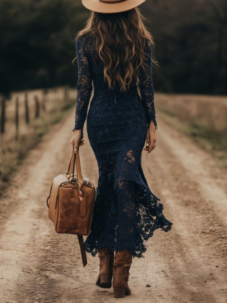 Navy lace long sleeve midi dress with mermaid hem, worn with cowboy boots and hat.
