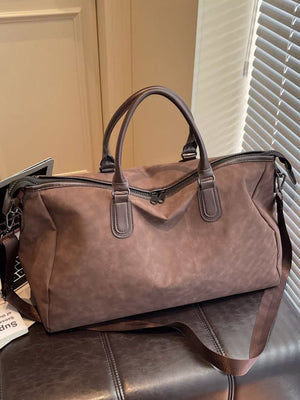 Chocolate duffel bag with dual handles and adjustable strap, large capacity travel bag.