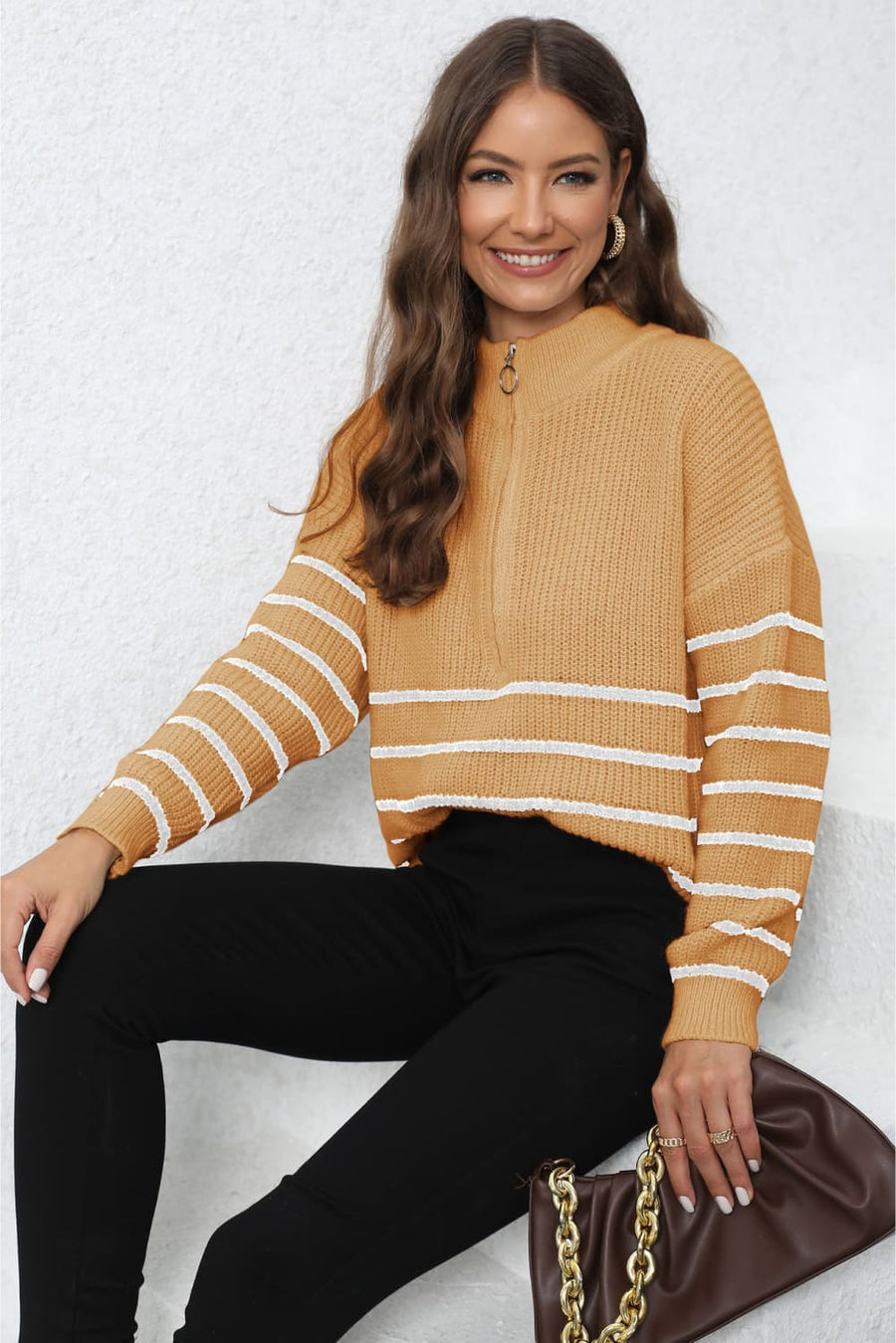 Tangerine ribbed knit quarter-zip sweater with white stripes on sleeves and body.