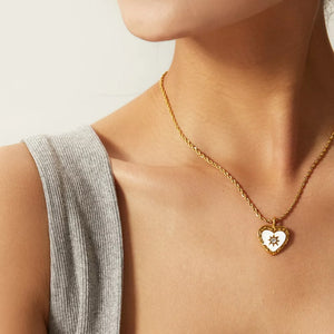 white necklace featuring heart pendant and motif