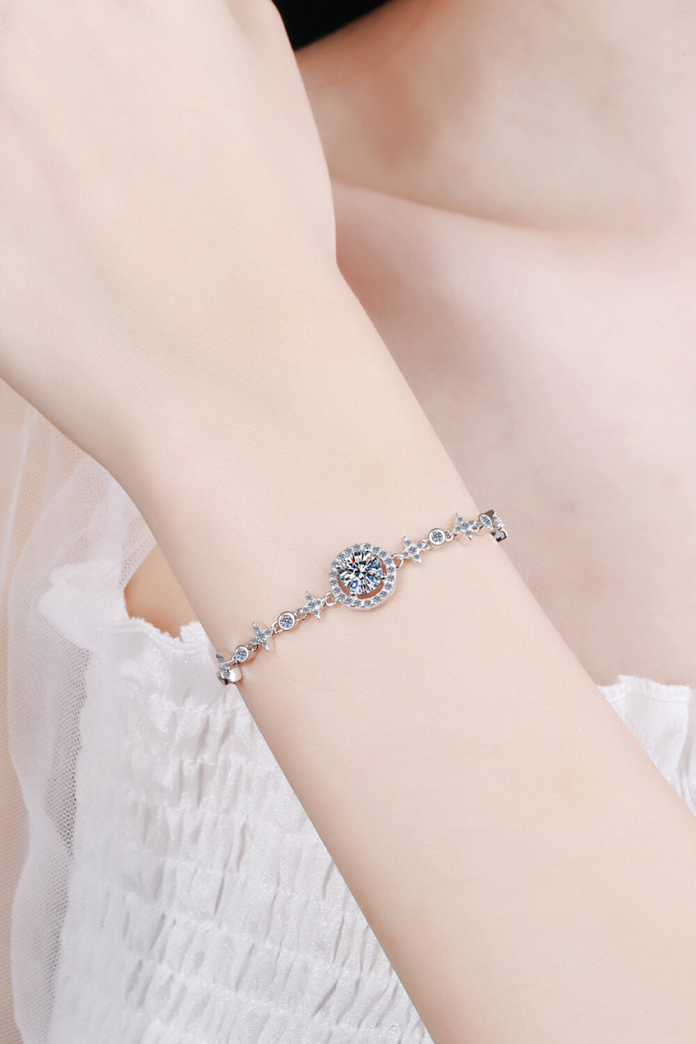 Silver moissanite bracelet with celestial halo design and star accents.