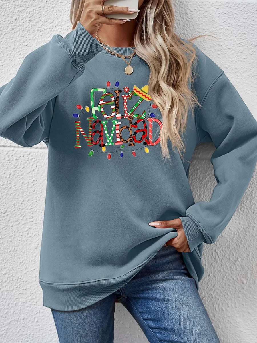 Misty Blue Feliz Navidad graphic sweatshirt with festive lights and sombrero detail.