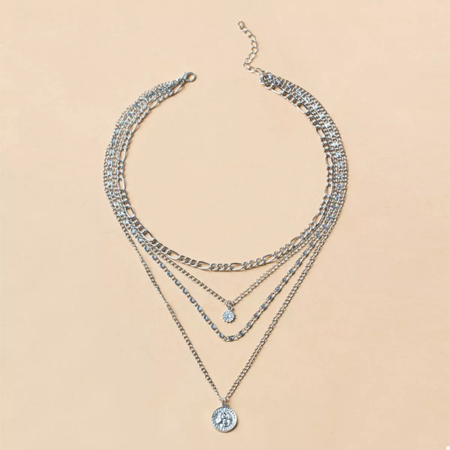 Silver layered necklace with coin pendant and crystal charm