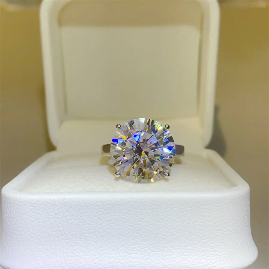 Radiant moissanite solitaire ring in silver, set in a white ring box.