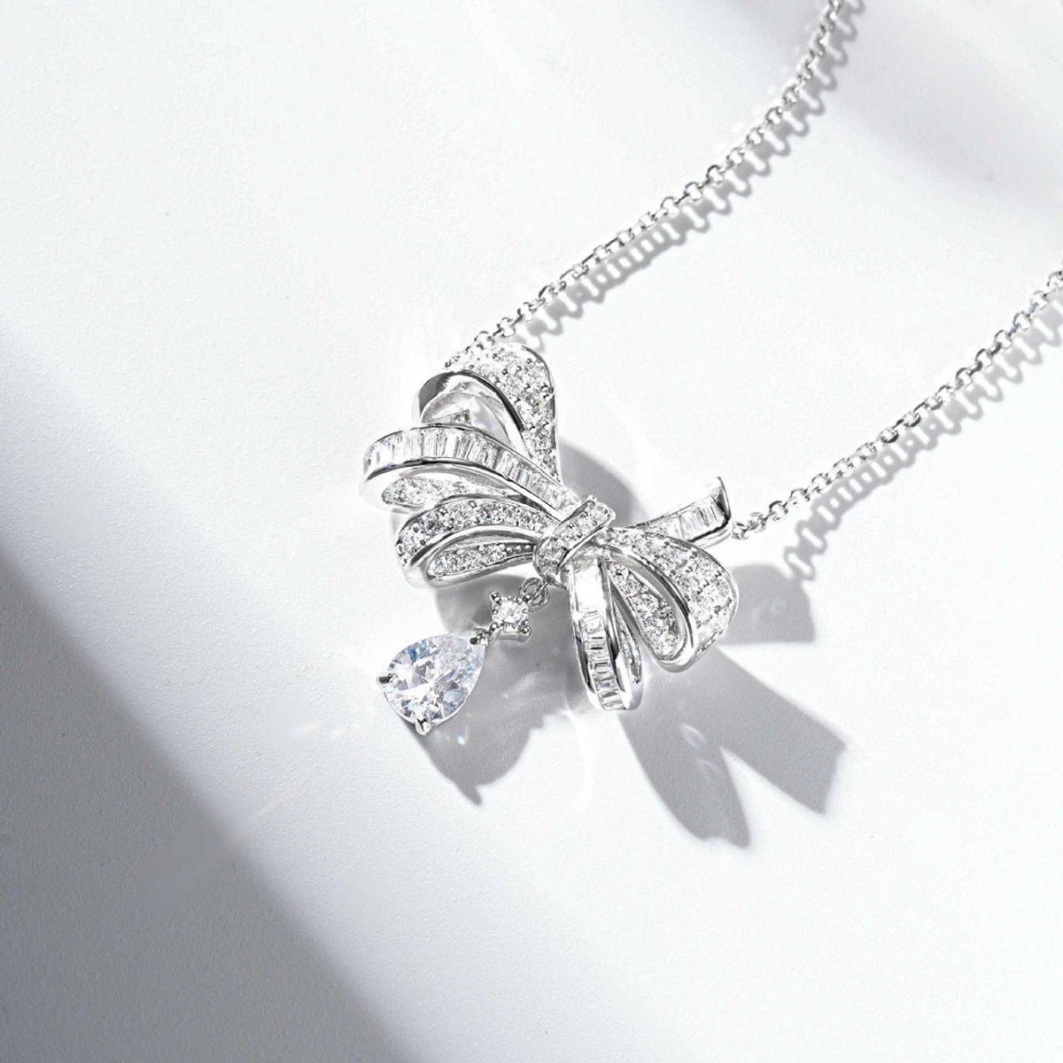 necklace in silver with bow design and princess