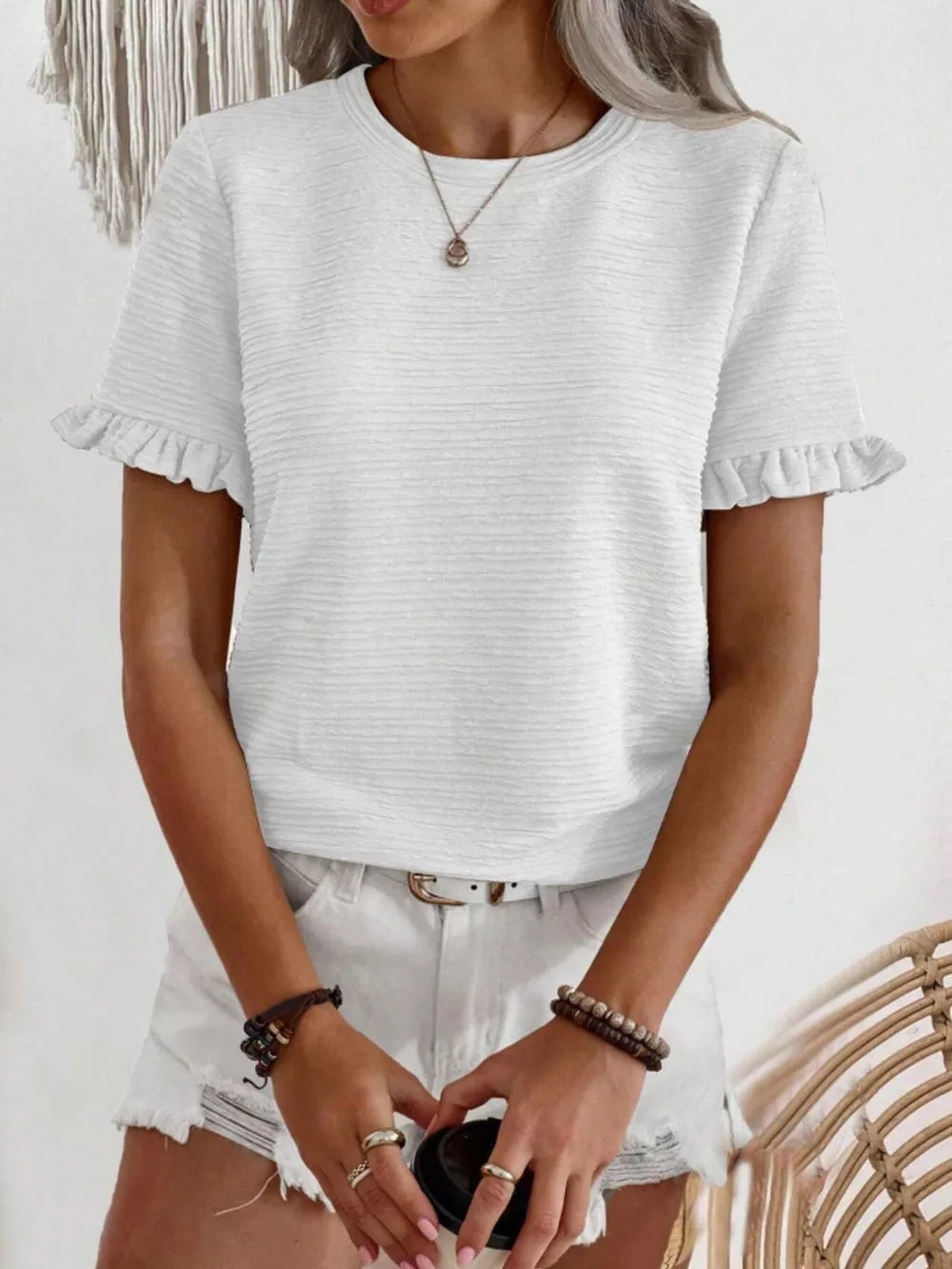 White textured t-shirt with ruffle short sleeves and crew neck.