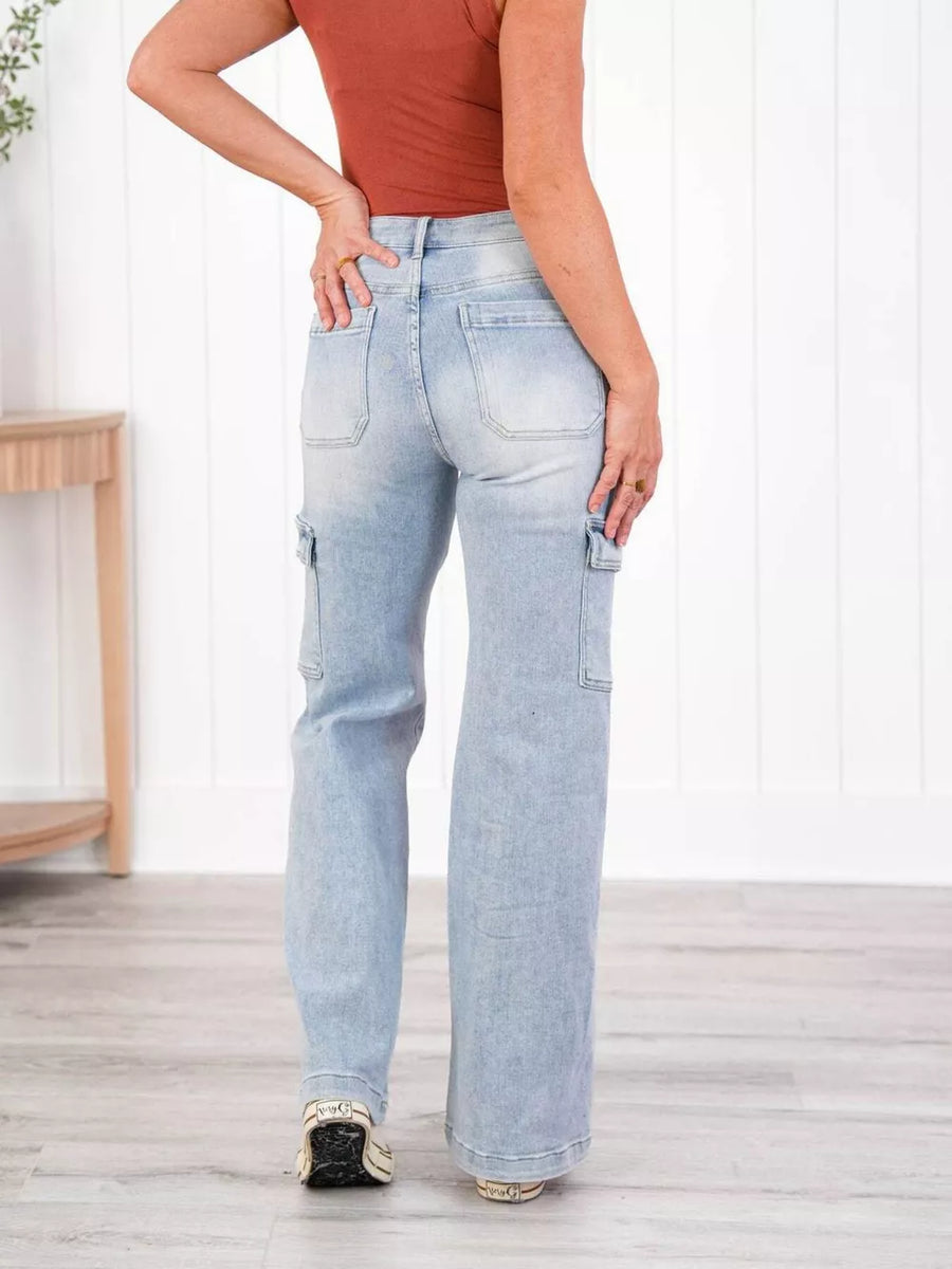 Light wash denim wide-leg cargo jeans with utility pockets and a relaxed fit.
