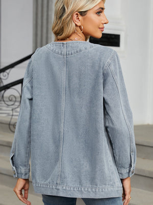 Light blue denim blazer with buttoned cuffs and a classic collarless neckline.