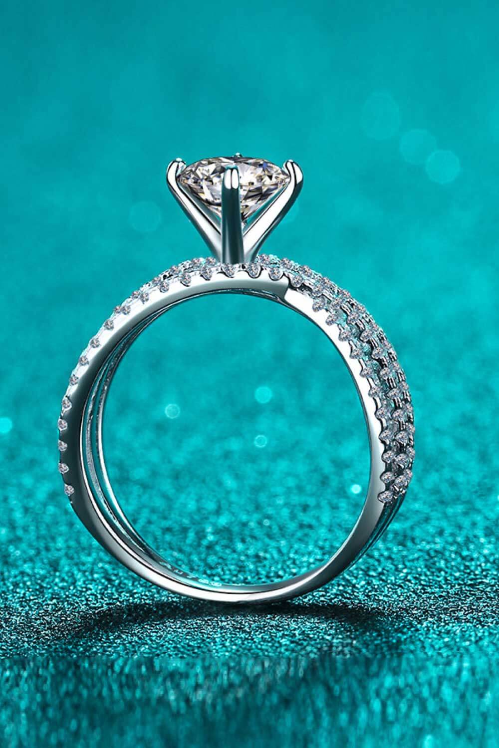 Silver pavé-set crossover engagement ring with a large center stone.