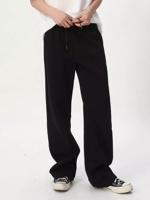 Black relaxed fit sweatpants with adjustable drawstring waist and wide leg