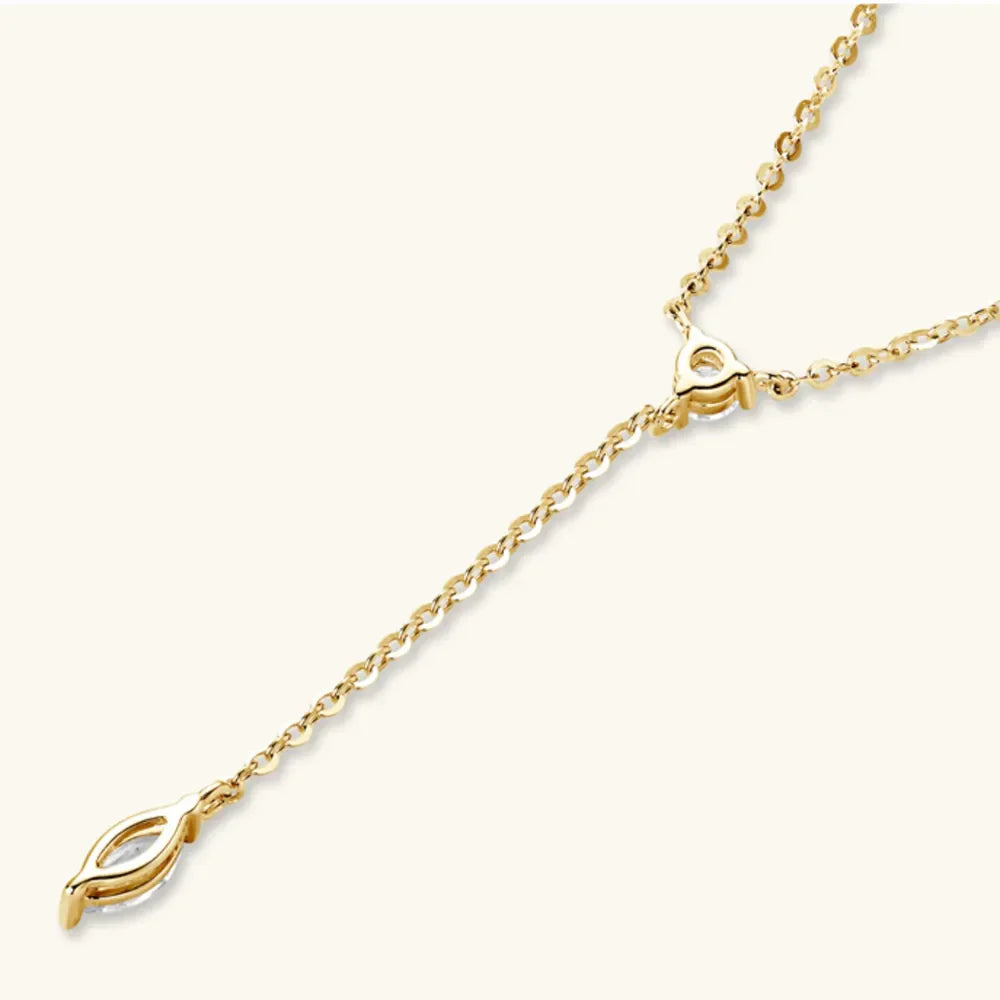 Gold lariat necklace with marquise moissanite pendant and delicate chain.