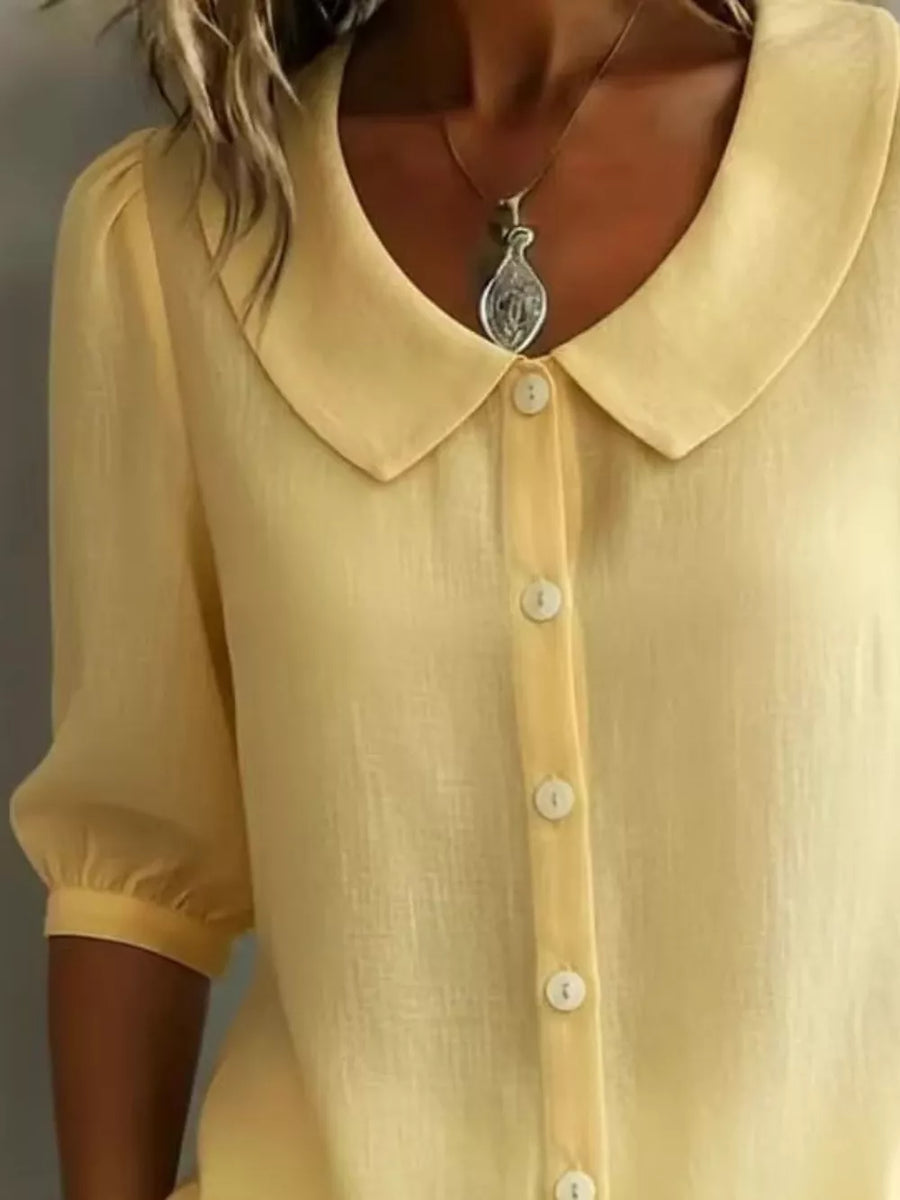 Yellow linen-look button-down shirt with Peter Pan collar and puff sleeves.