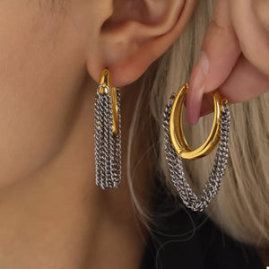 Chunky gold hoop earrings with silver chain fringe detail.