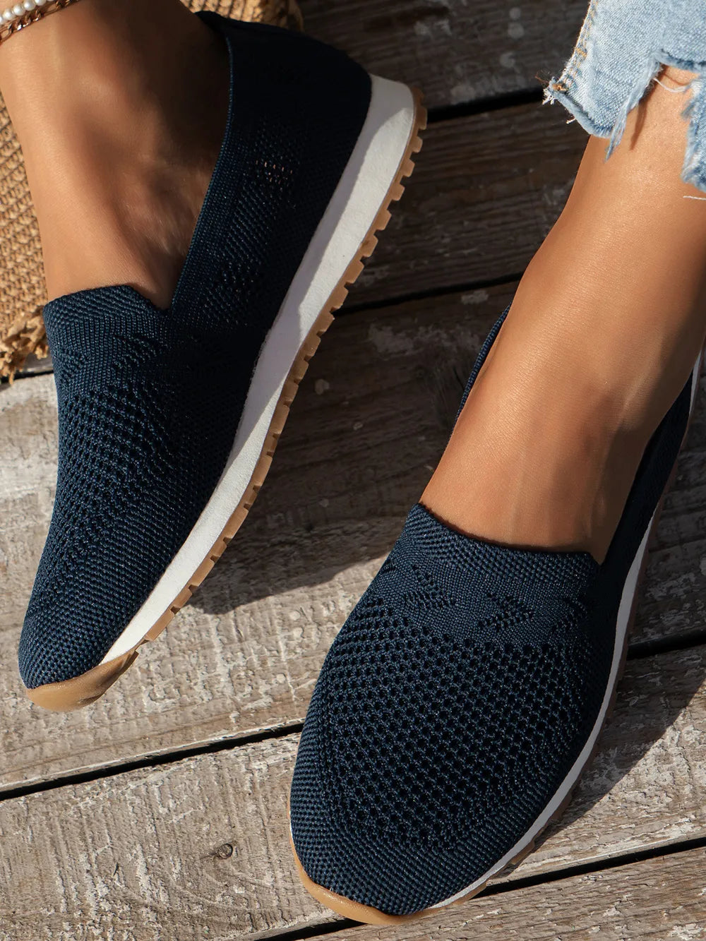 Dark Navy breathable knit slip-on sneakers with white soles and tan trim.