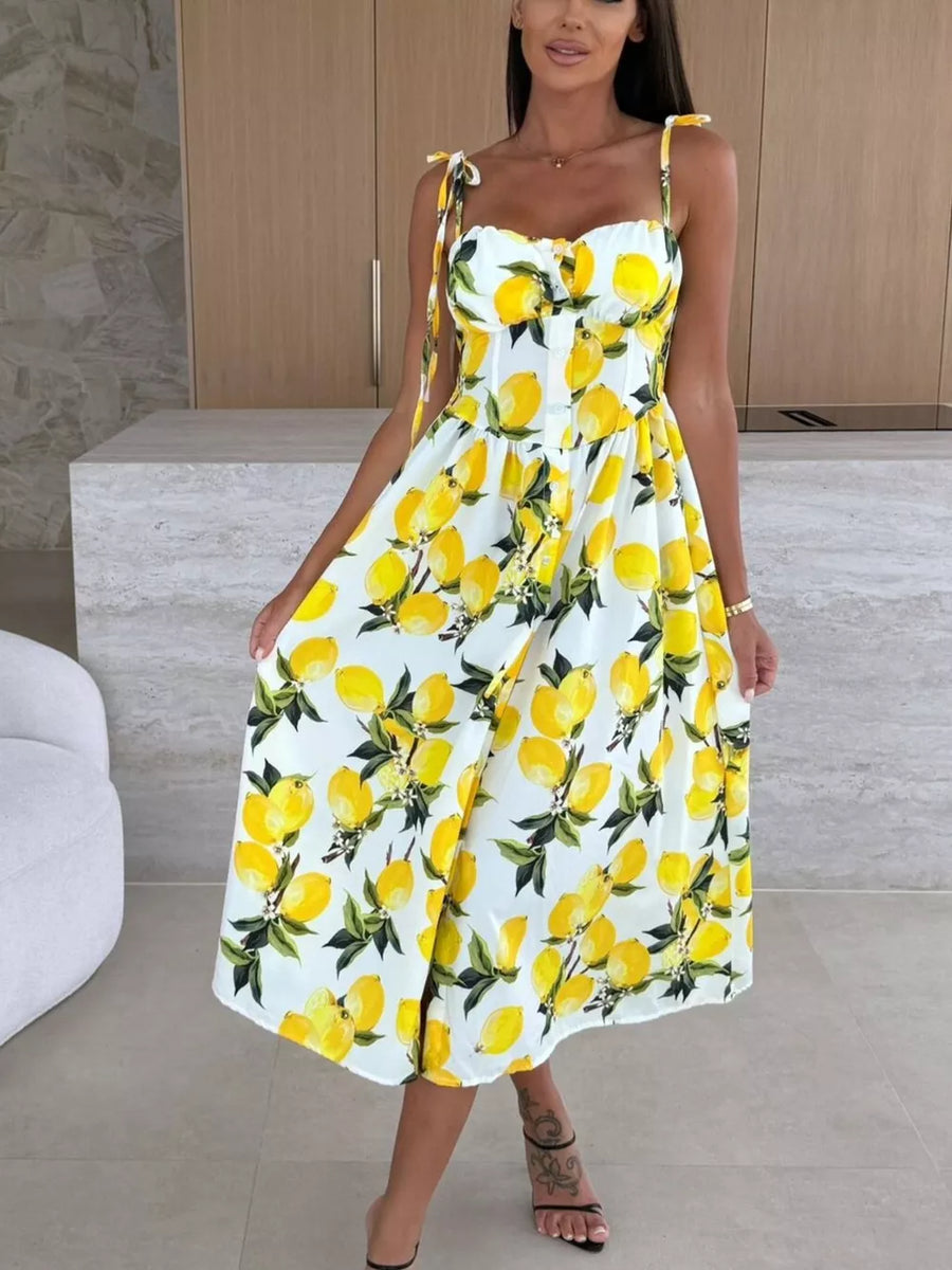 Floral tie-strap midi dress with lemon print and A-line skirt.