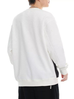 White crew-neck sweatshirt with a textured chevron pattern and ribbed cuffs.