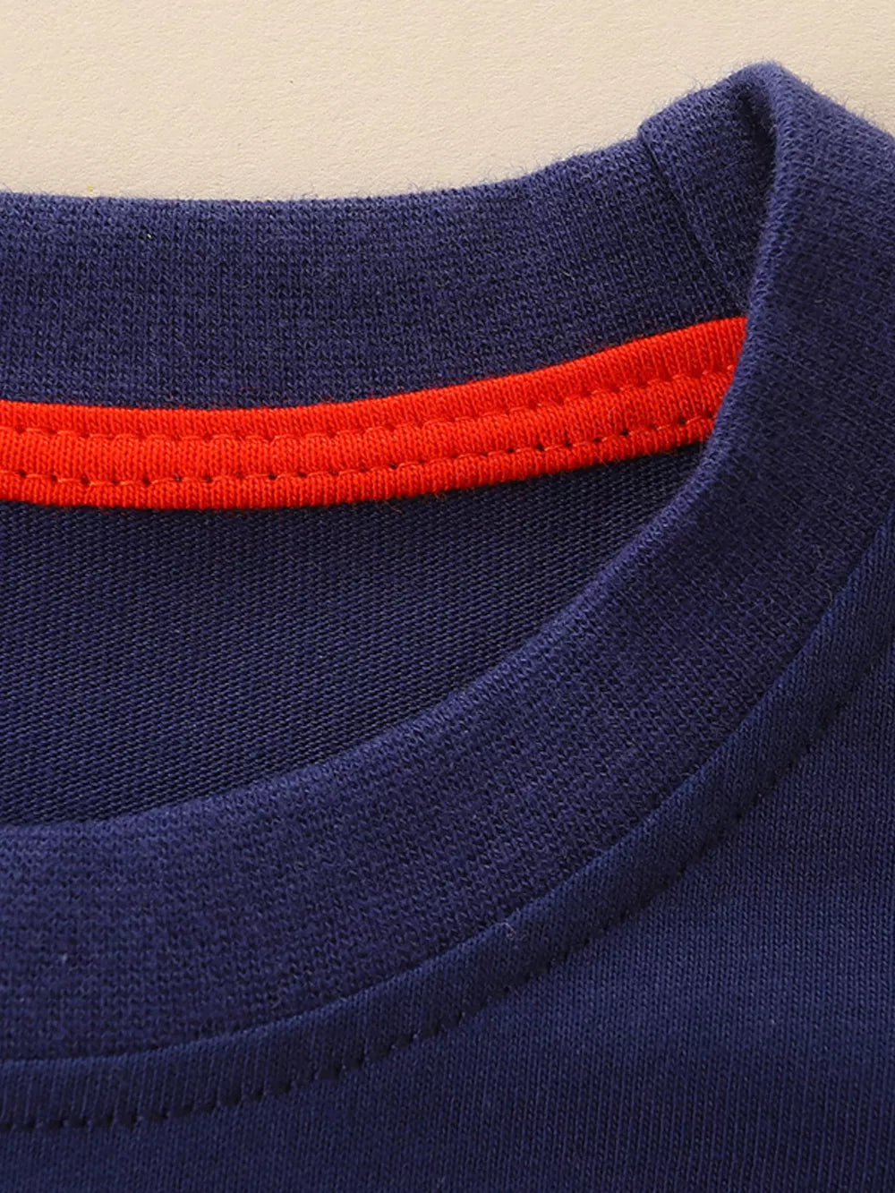 Navy cotton crew neck toddler t-shirt with red trim detail.