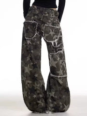 Star-embellished distressed wide-leg jeans with raw hem detail.