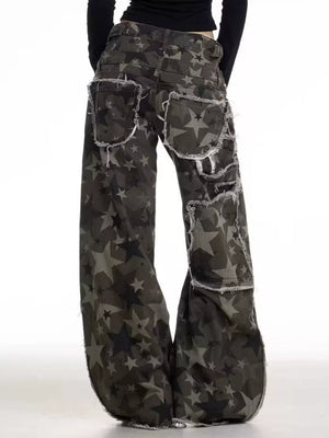 Star-embellished distressed wide-leg jeans with raw hem detail.