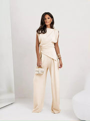 Elegant satin cowl neck two-piece set in tan with wide leg pants and asymmetrical wrap detail.