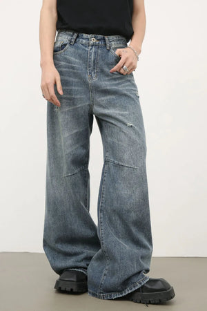 Distressed edge wide-leg jeans in medium wash denim with a relaxed fit.
