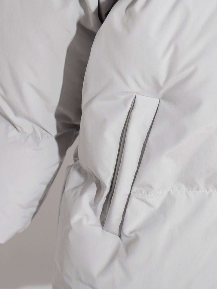 Light gray puffer jacket with a visible pocket