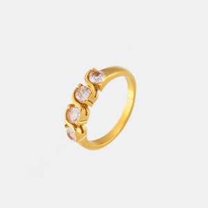 Gold band ring with five clear cubic zirconia stones in a wave-set design.