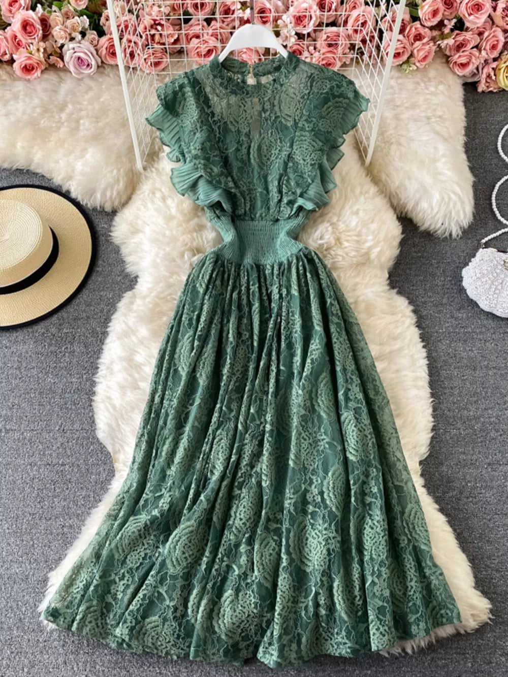 Emerald green lace maxi dress with ruffled short sleeves and cutout waist.