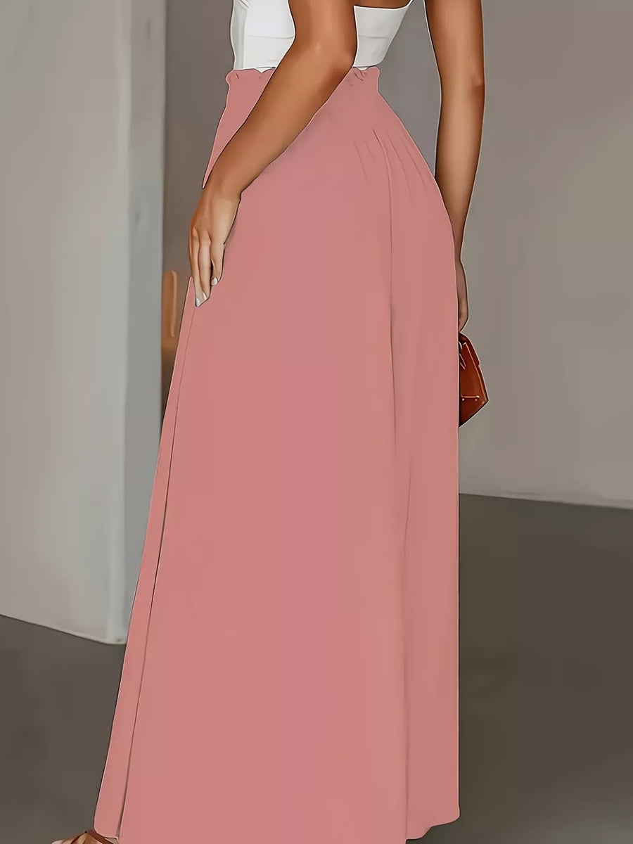 Pale blush wide-leg pants with paperbag waist and a flowing silhouette.