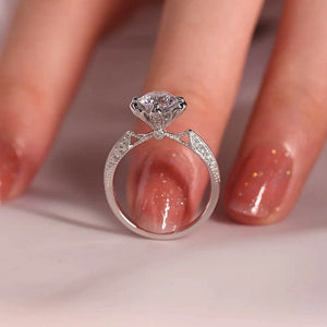 Sterling silver ring with moissanite center stone and diamond accents on band