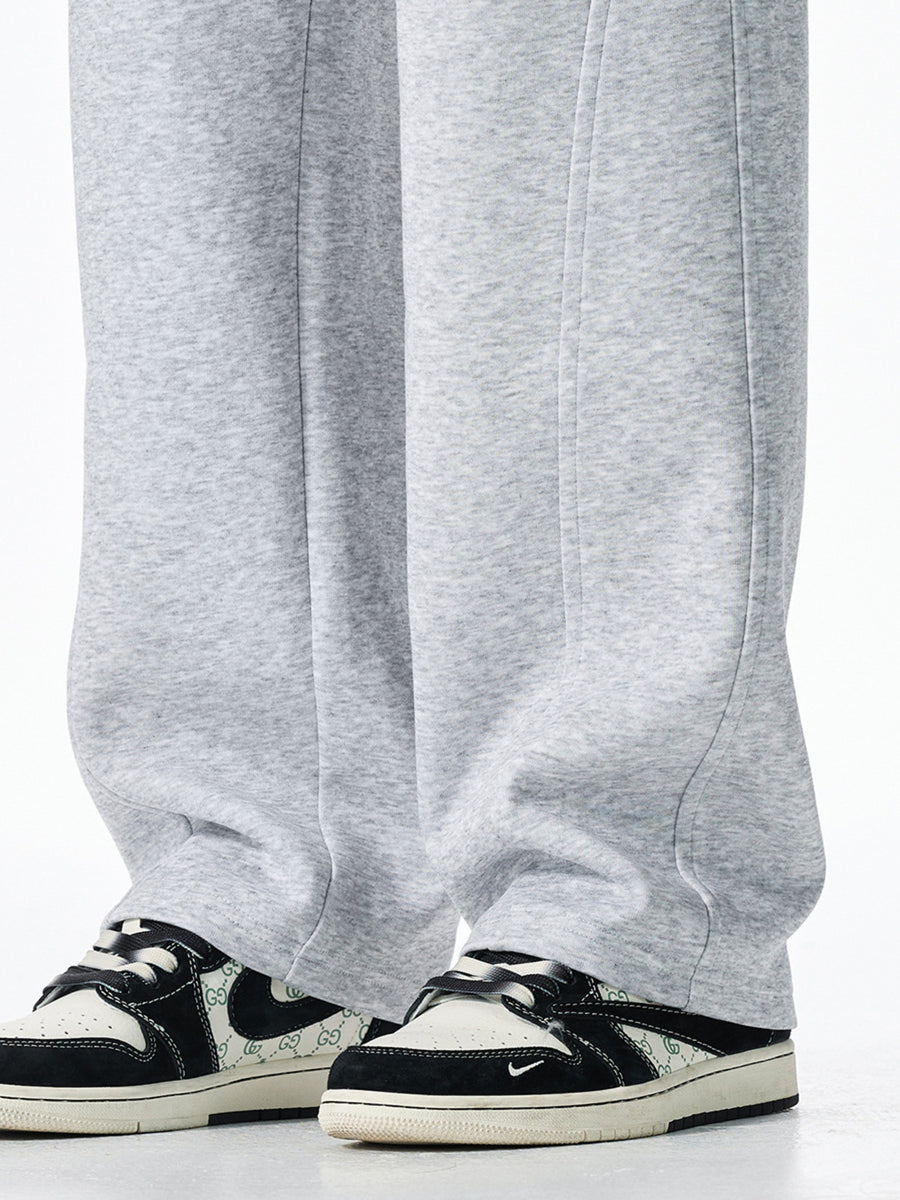 Men's grey casual loose-fit sweatpants with drawstring detail and visible stitching.