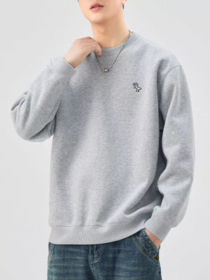 Gray long-sleeve sweatshirt with embroidered dinosaur detail and crew neck.