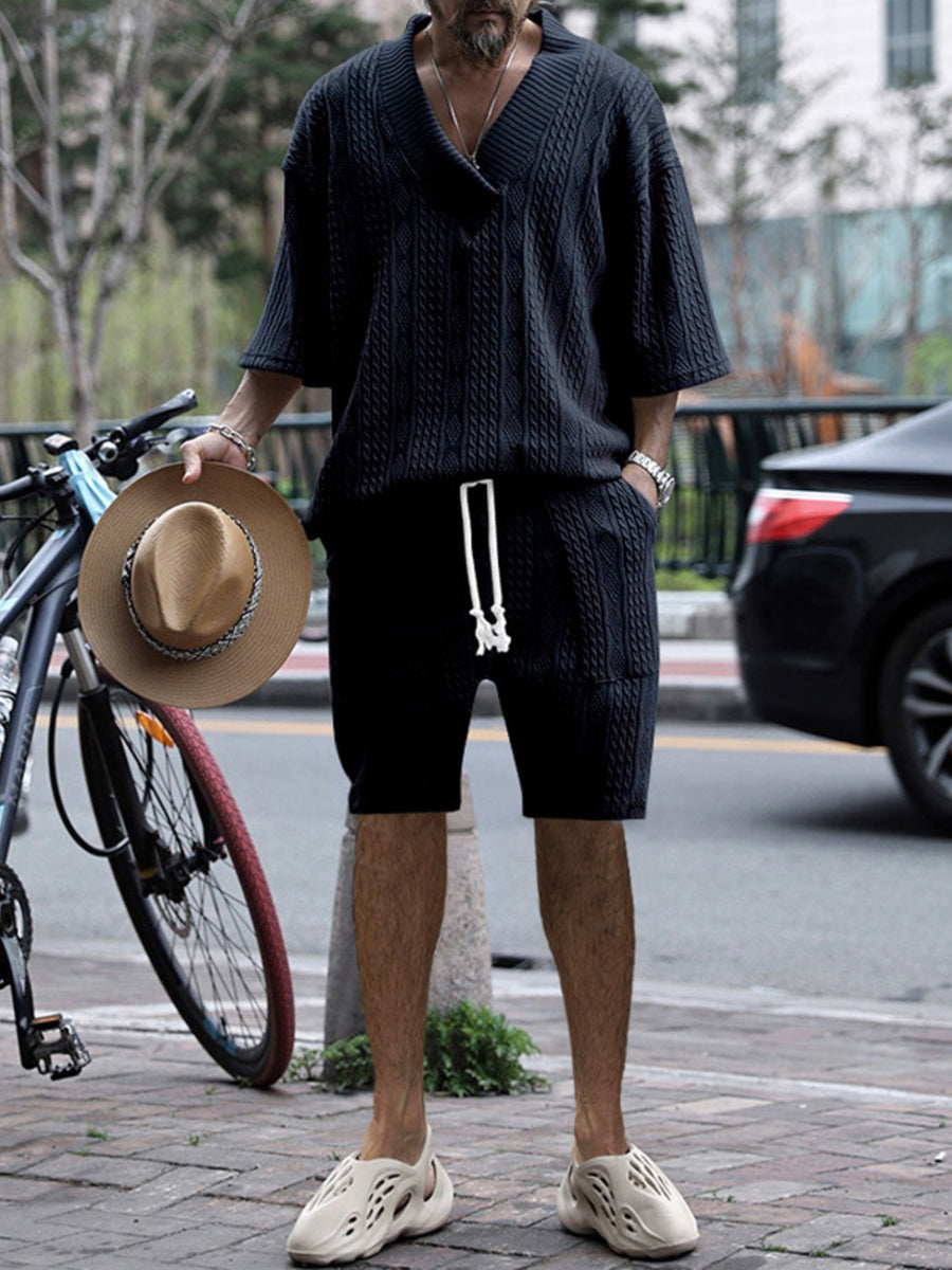 Men's navy blue cable-knit v-neck two-piece set with shorts and short-sleeve top.