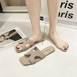 Beige suede H-strap sliders sandals with open square toe.