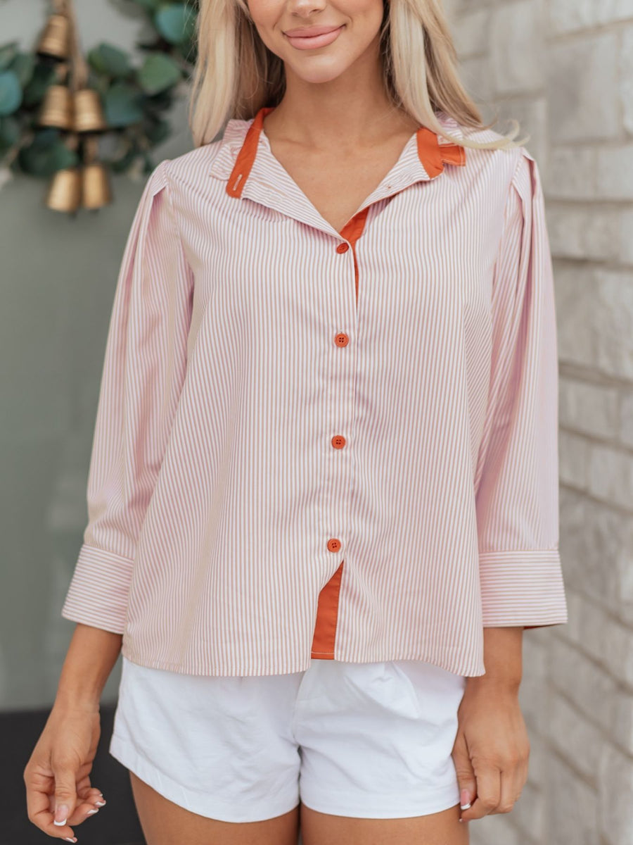 Pink striped maternity shirt with orange collar and buttons, button-down style.