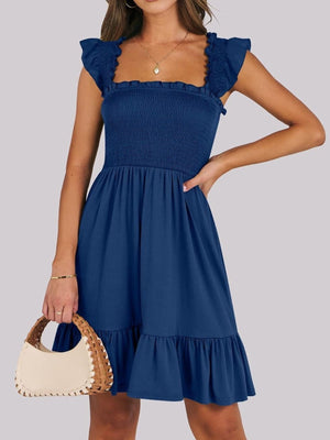 Navy smocked square neck mini dress with ruffle sleeves and hem.