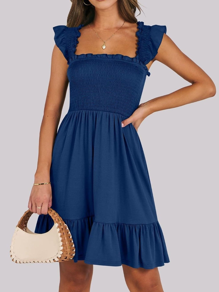 Navy smocked square neck mini dress with ruffle sleeves and hem.