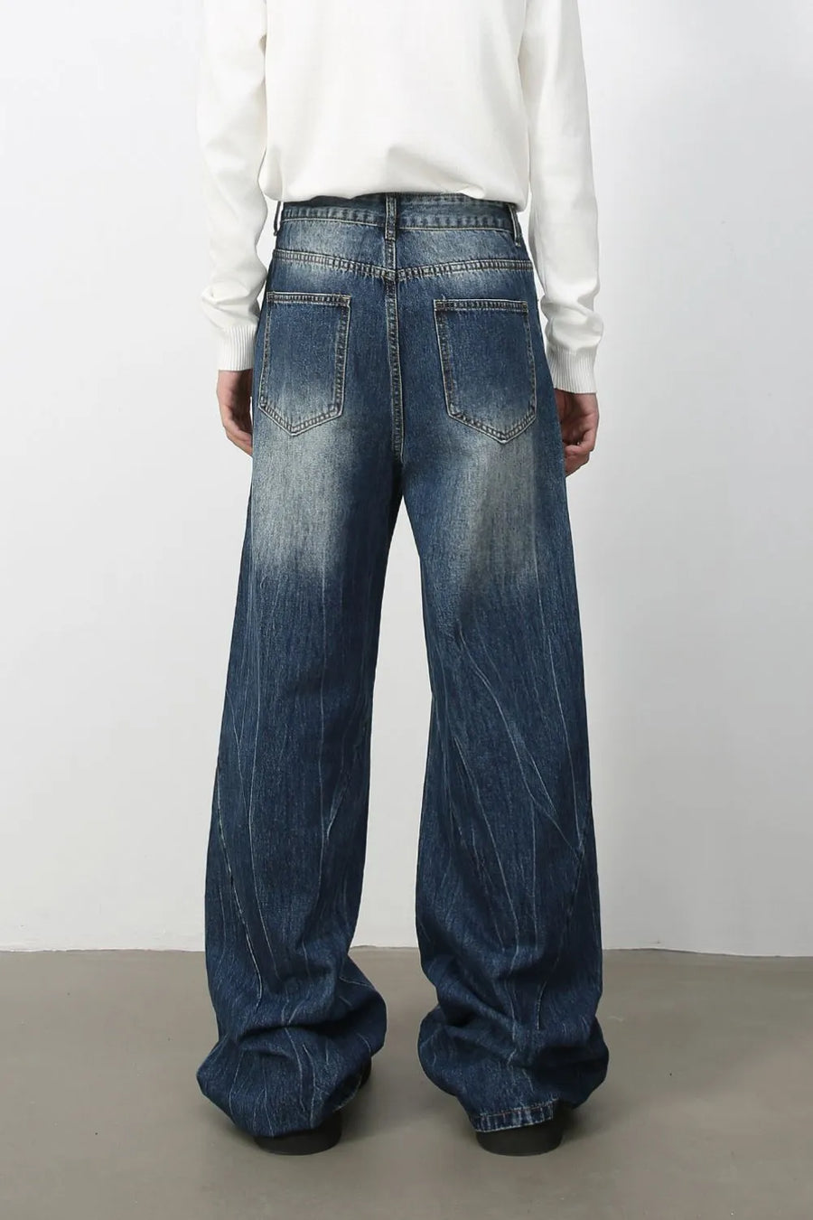 Oversized palazzo jeans in medium wash denim with a faded effect and vertical pinstripe texture.