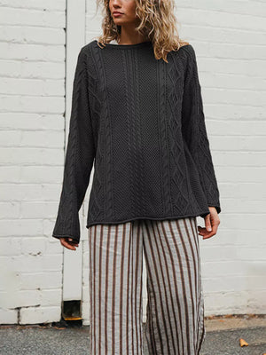Black pullover sweater featuring cable-knit and cable knit