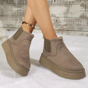 Caramel suede round toe platform ankle boots with faux fur trim and elastic side panels.